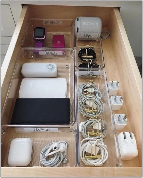 Electronics drawer with cords coiled and clipped into labelled trays