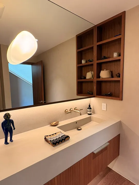 Staged powder room vanity with styled counter in a Vancouver home